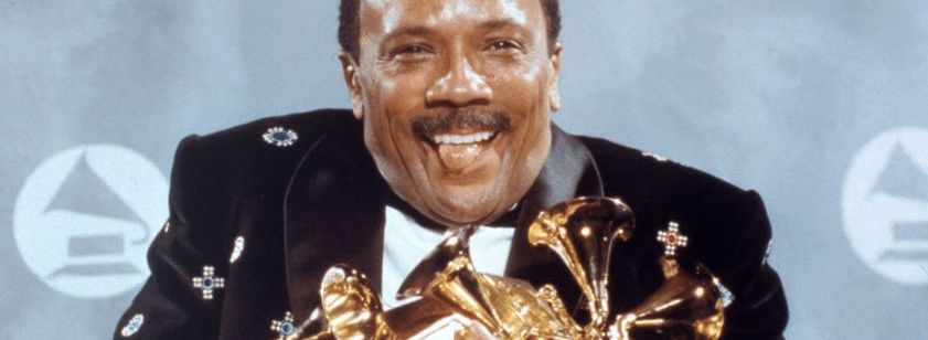 American Masters - Quincy Jones: In the Pocket Photo: Susan Ragan 1991

A picture of music producer Quincy Jones sticking out his tongue while holding many Grammys.